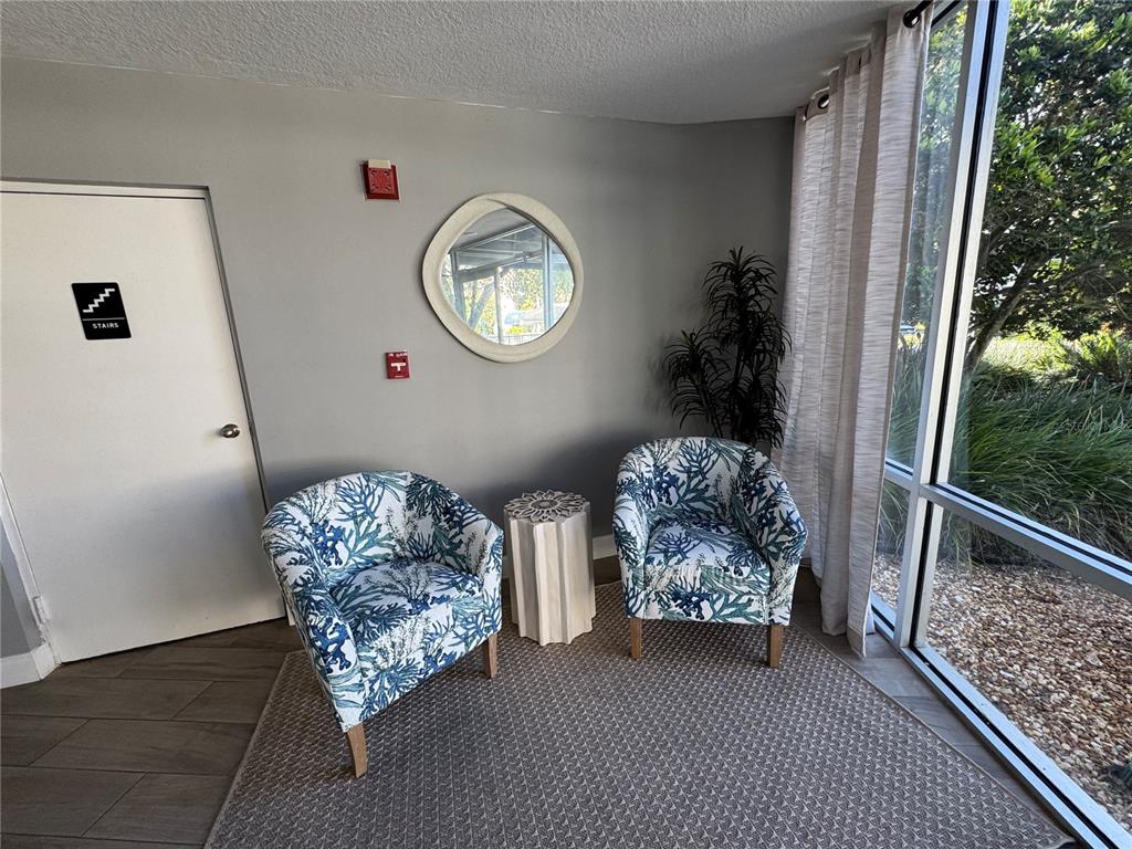 5567 Sea Forest Drive, Unit 319 New Port Richey, FL 34652 - Photo 6 of 34 a living room with furniture and a window