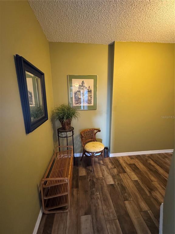 5567 Sea Forest Drive, Unit 319 New Port Richey, FL 34652 - Photo 9 of 34 a bedroom with a bed and wooden floor