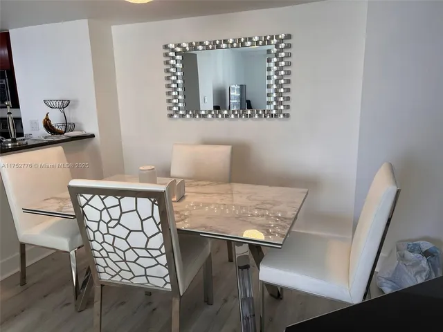a view of a workspace with furniture and wooden floor