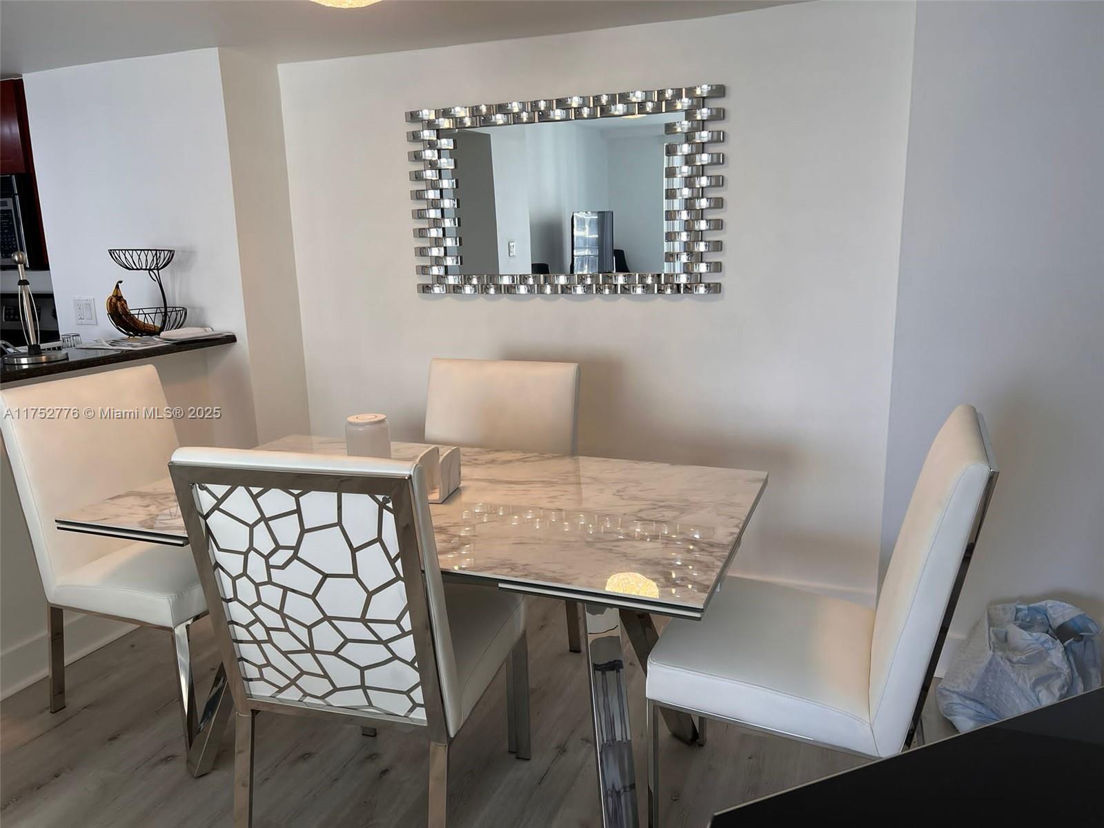 770 Claughton Island Drive, Unit 1913 Miami, FL 33131 - Photo 5 of 9 a view of a workspace with furniture and wooden floor