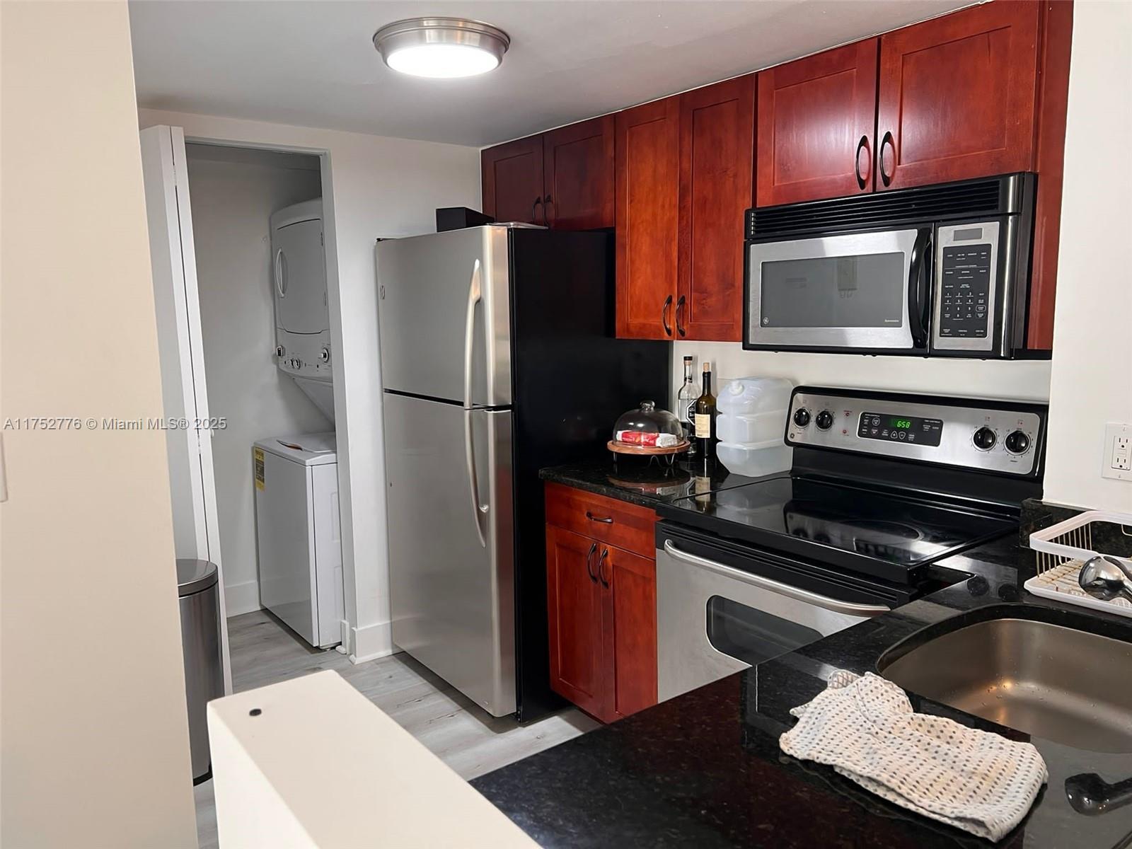 770 Claughton Island Drive, Unit 1913 Miami, FL 33131 - Photo 6 of 9 a kitchen with a refrigerator stove and microwave