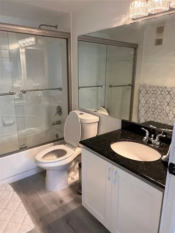 a bathroom with a toilet a sink and shower
