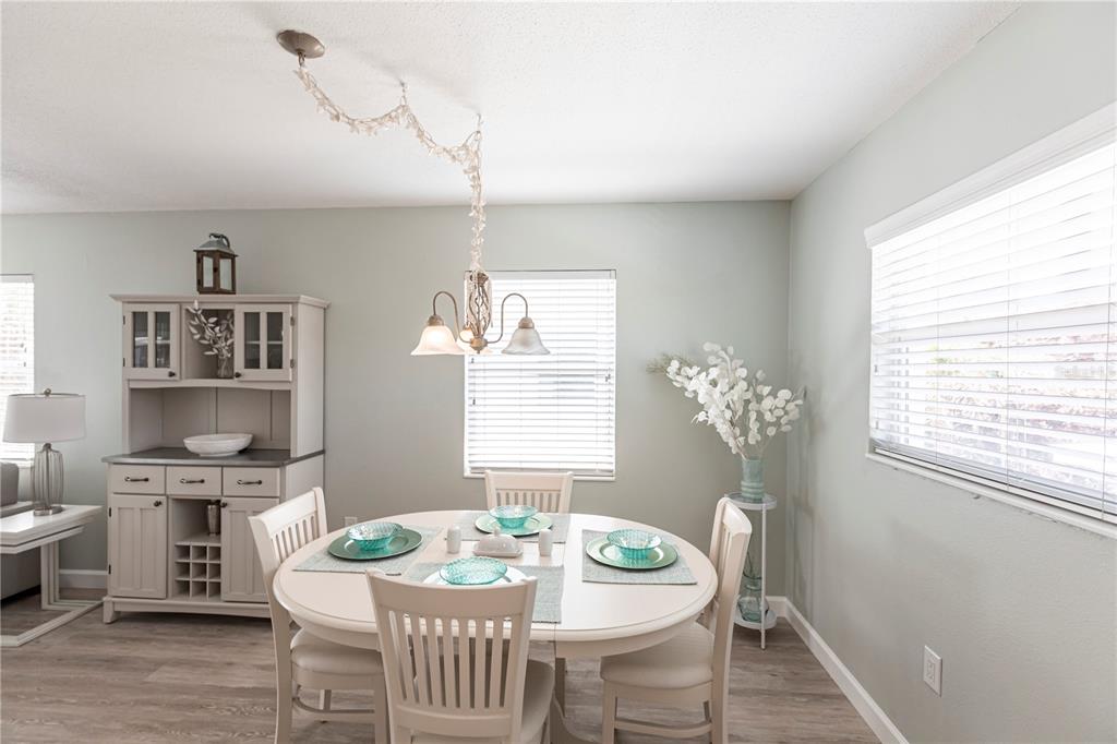 6020 Midnight Pass Road, Unit 11 Sarasota, FL 34242 - Photo 13 of 29 a view of a dining room with furniture window and wooden floor