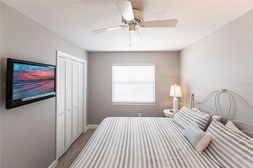 6020 Midnight Pass Road, Unit 11 Sarasota, FL 34242 - Photo 16 of 29 a bedroom with a bed and a painting on the wall