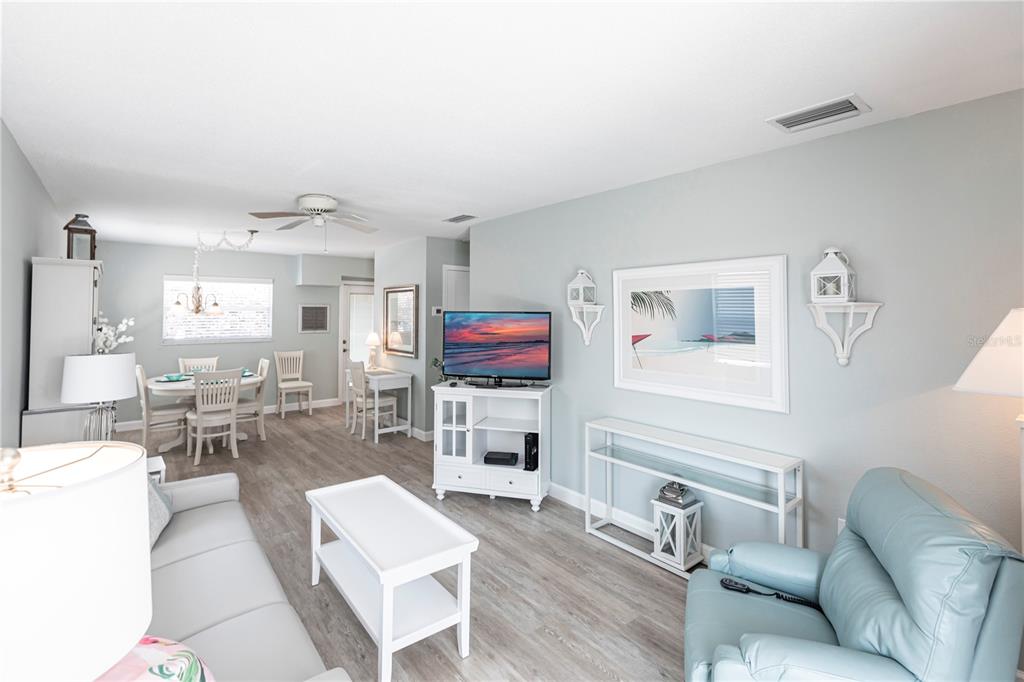 6020 Midnight Pass Road, Unit 11 Sarasota, FL 34242 - Photo 2 of 29 a living room with furniture and a flat screen tv