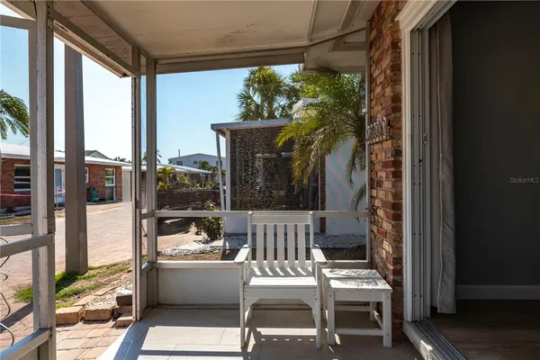 a view of balcony with furniture and garden