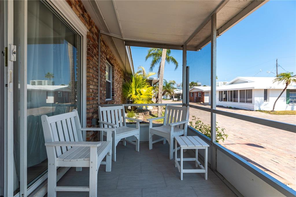 6020 Midnight Pass Road, Unit 11 Sarasota, FL 34242 - Photo 3 of 29 a view of a balcony with chairs