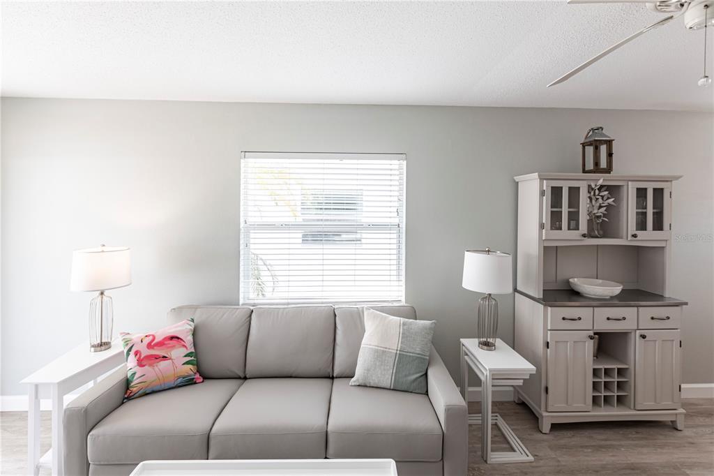 6020 Midnight Pass Road, Unit 11 Sarasota, FL 34242 - Photo 7 of 29 a living room with furniture and a window