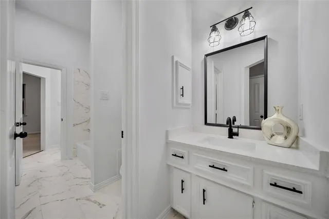 a living room with furniture and a ceiling fan
