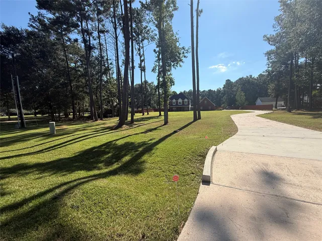 a kitchen with stainless steel appliances granite countertop a stove top oven a refrigerator a sink and dishwasher with wooden floor