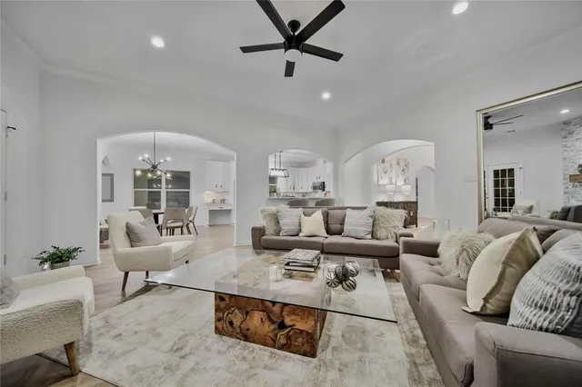 a view of a livingroom with wooden floor and stairs