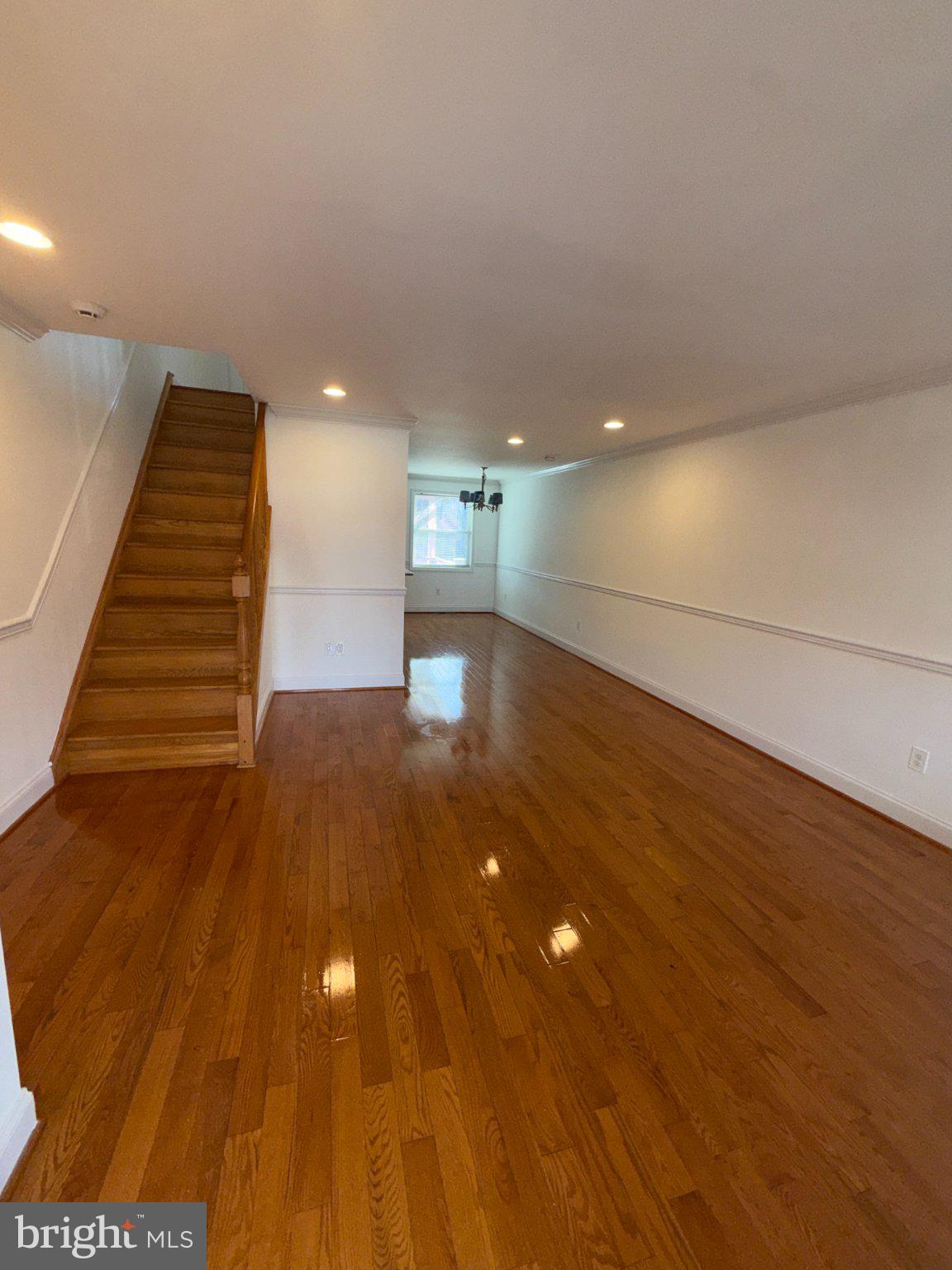 1907 Penhall Road Dundalk, MD 21222 - Photo 4 of 64 a view of a room with stairs and a wooden floor