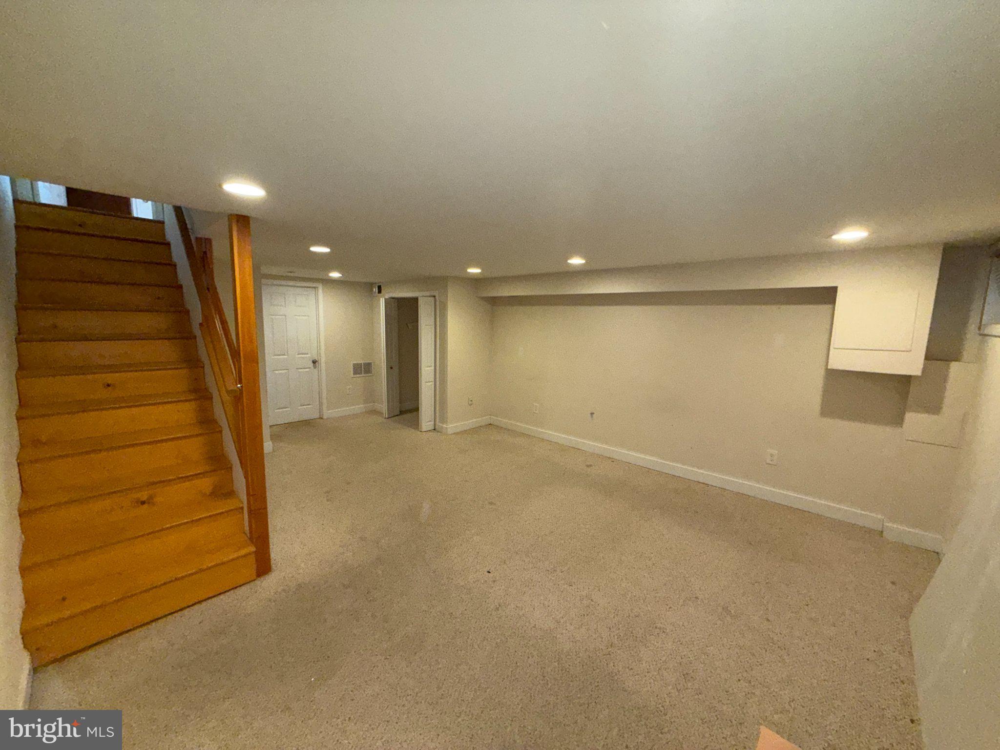 1907 Penhall Road Dundalk, MD 21222 - Photo 44 of 64 Spacious basement with warm lighting.