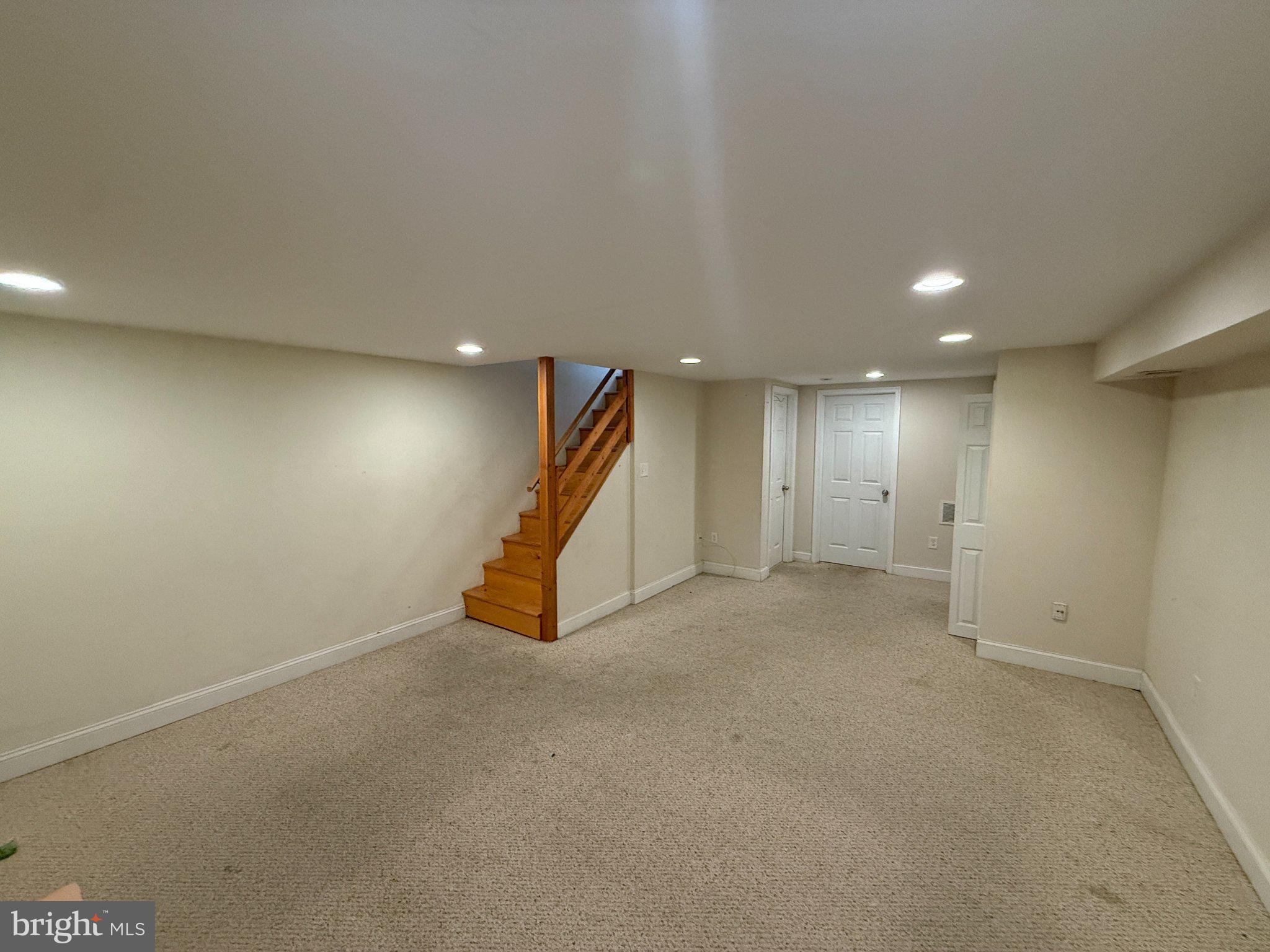 1907 Penhall Road Dundalk, MD 21222 - Photo 45 of 64 an empty room with a projector and white walls