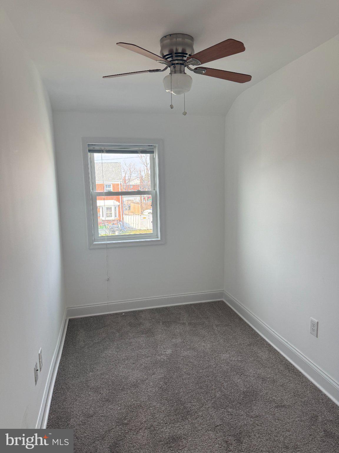 1907 Penhall Road Dundalk, MD 21222 - Photo 56 of 64 an empty room with a window and a fan