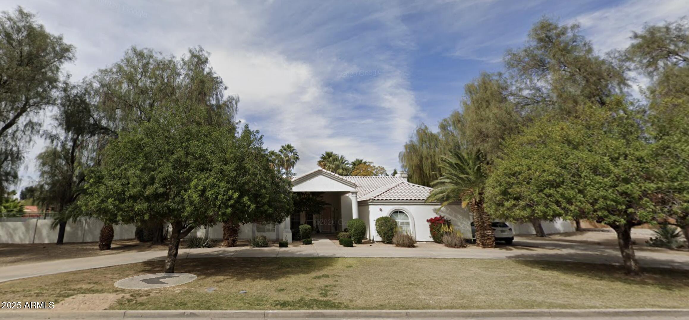 a view of a white house with a sink and backyard