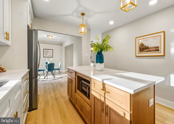 a view of a kitchen area with furniture and wooden floor