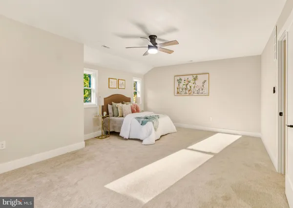 a bedroom with a bed and a ceiling fan