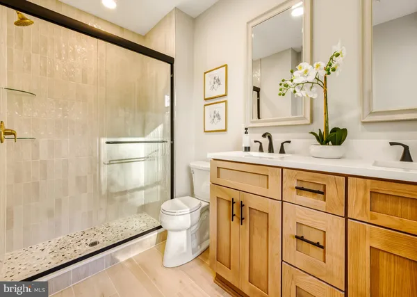 a bathroom with a sink a toilet and a mirror