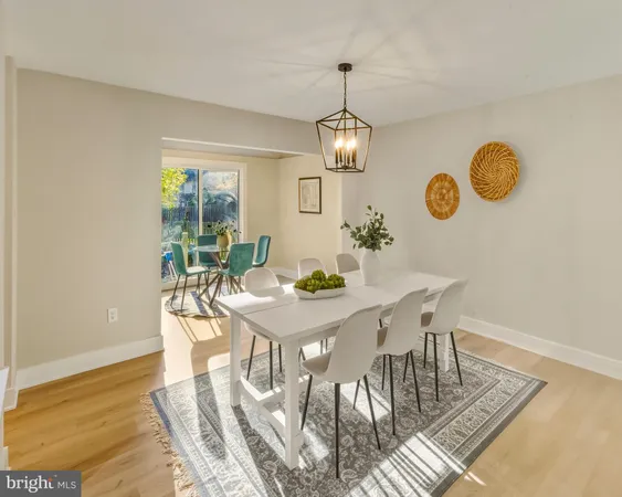 a view of a dining room with furniture wooden floor and chandelier