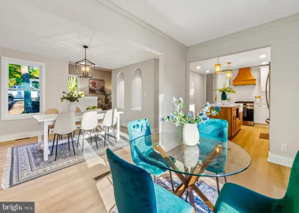 a dining room with furniture a chandelier and a dining table