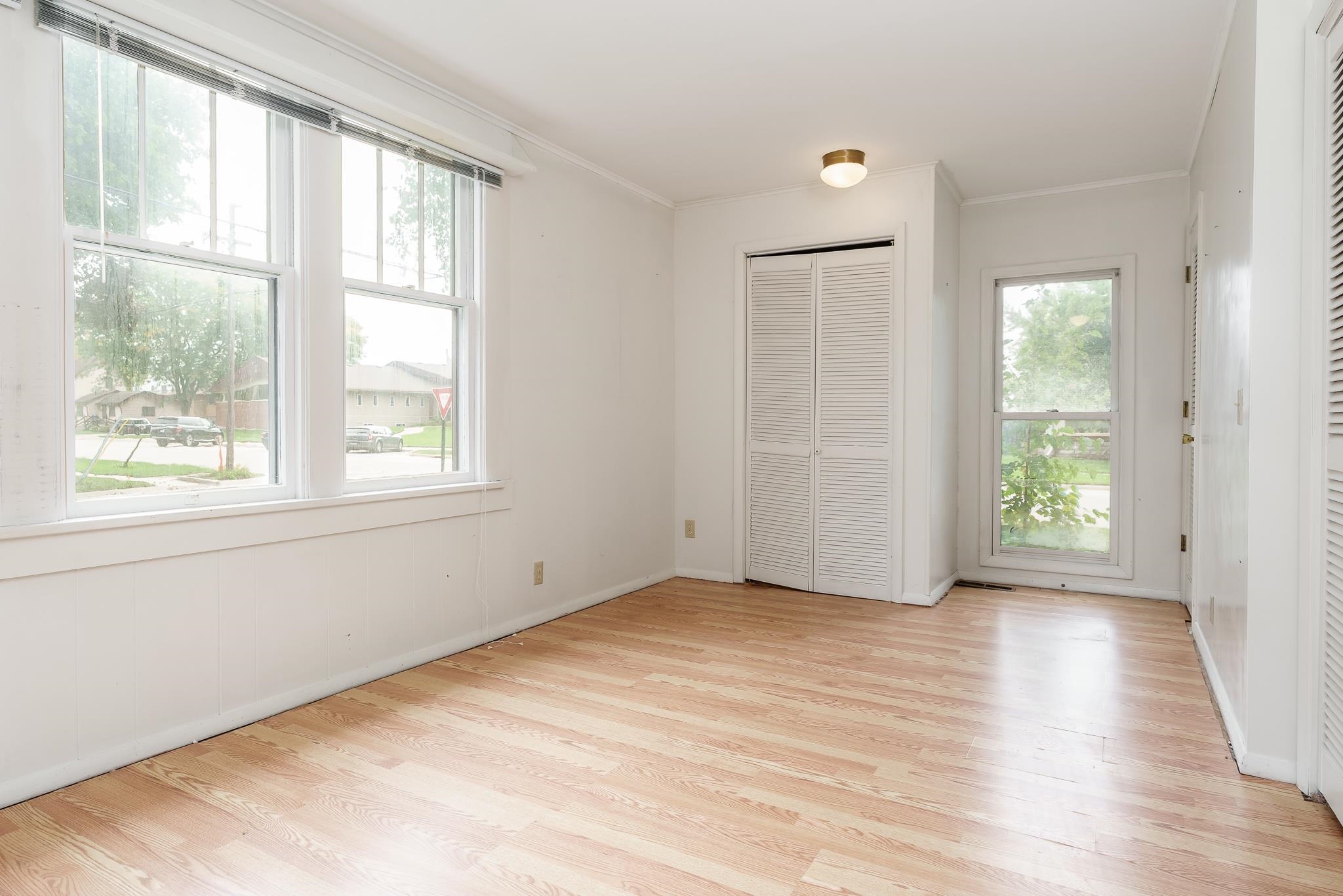 305 West 3rd Street Byron, IL 61010 - Photo 11 of 37 a view of an empty room with wooden floor and a window