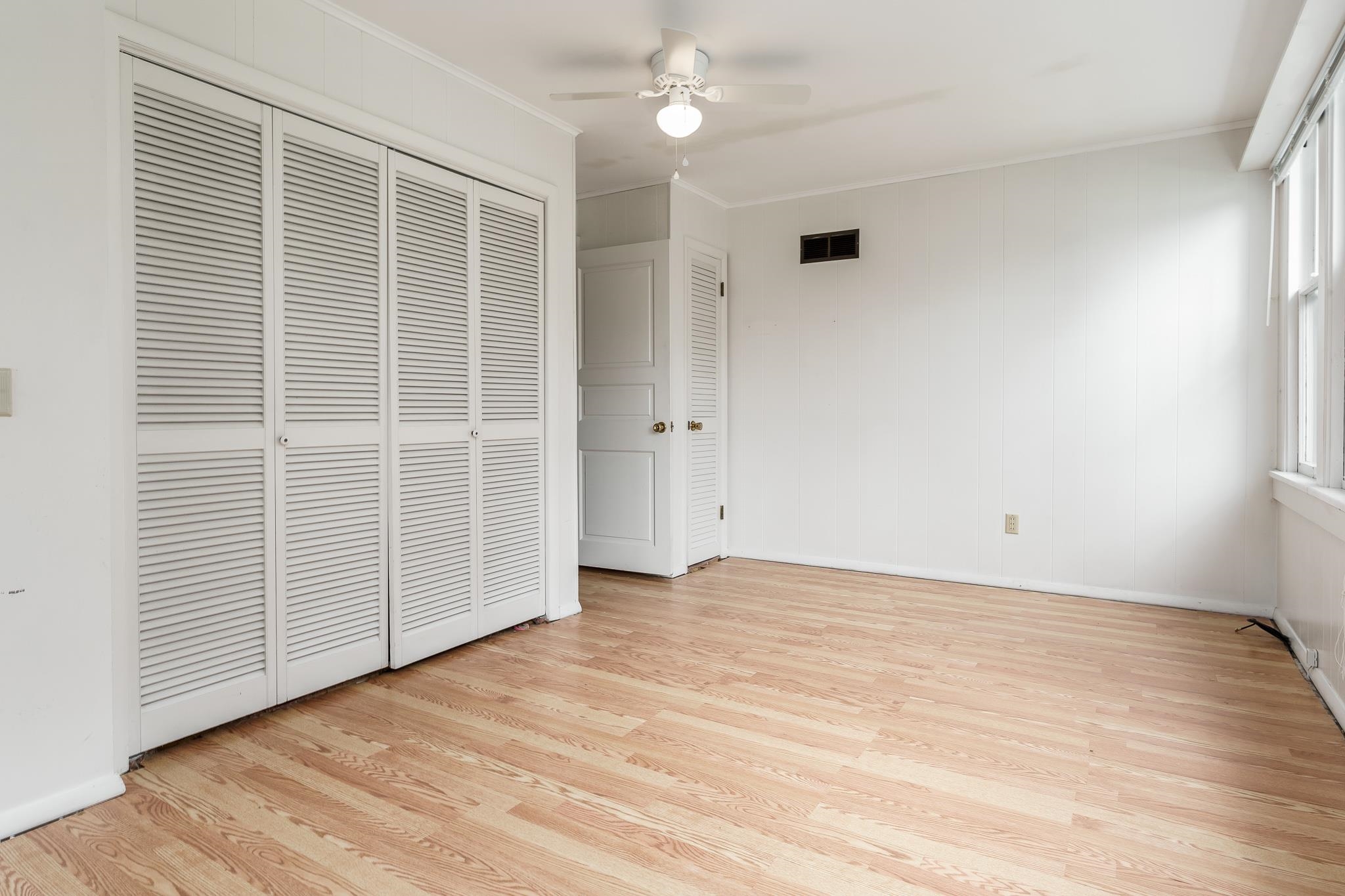 305 West 3rd Street Byron, IL 61010 - Photo 12 of 37 an empty room with wooden floor and windows