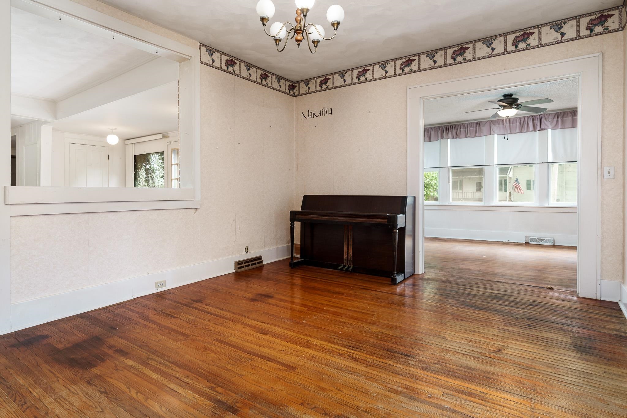 305 West 3rd Street Byron, IL 61010 - Photo 14 of 37 a view of an empty room with wooden floor and a window