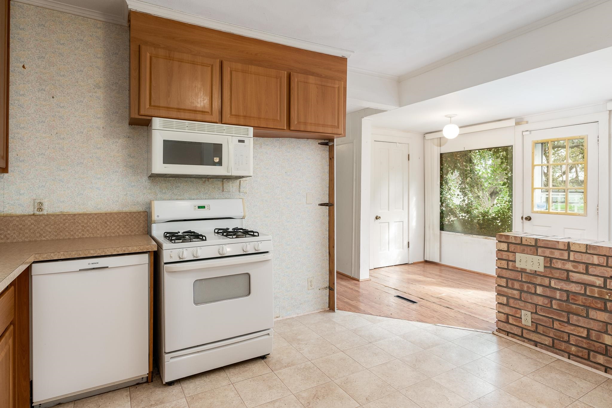 305 West 3rd Street Byron, IL 61010 - Photo 18 of 37 a kitchen with stainless steel appliances granite countertop a stove and a microwave