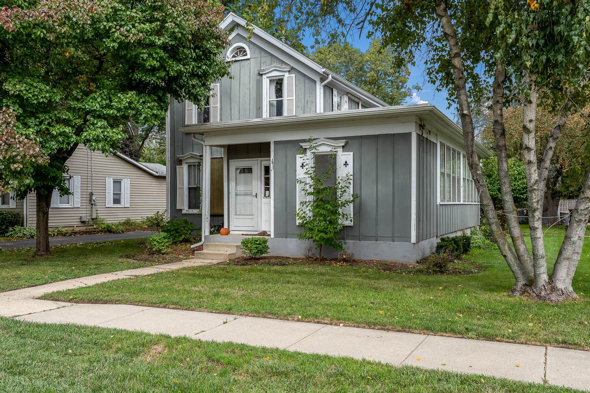 305 West 3rd Street Byron, IL 61010 - Photo 2 of 37 a front view of a house with a yard and porch