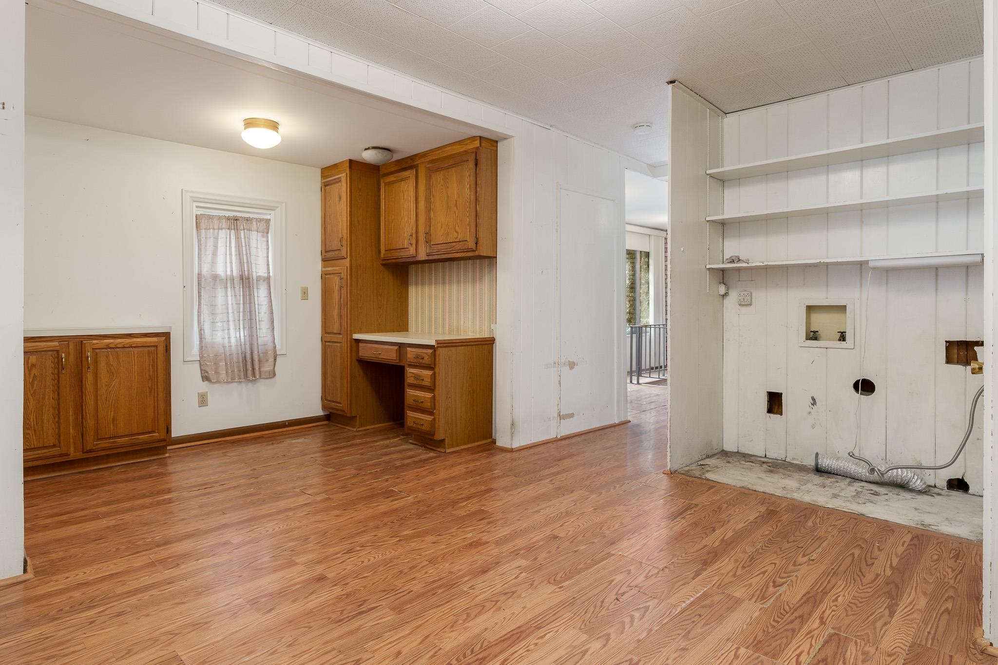 305 West 3rd Street Byron, IL 61010 - Photo 23 of 37 a view of an empty room with wooden floor and a window