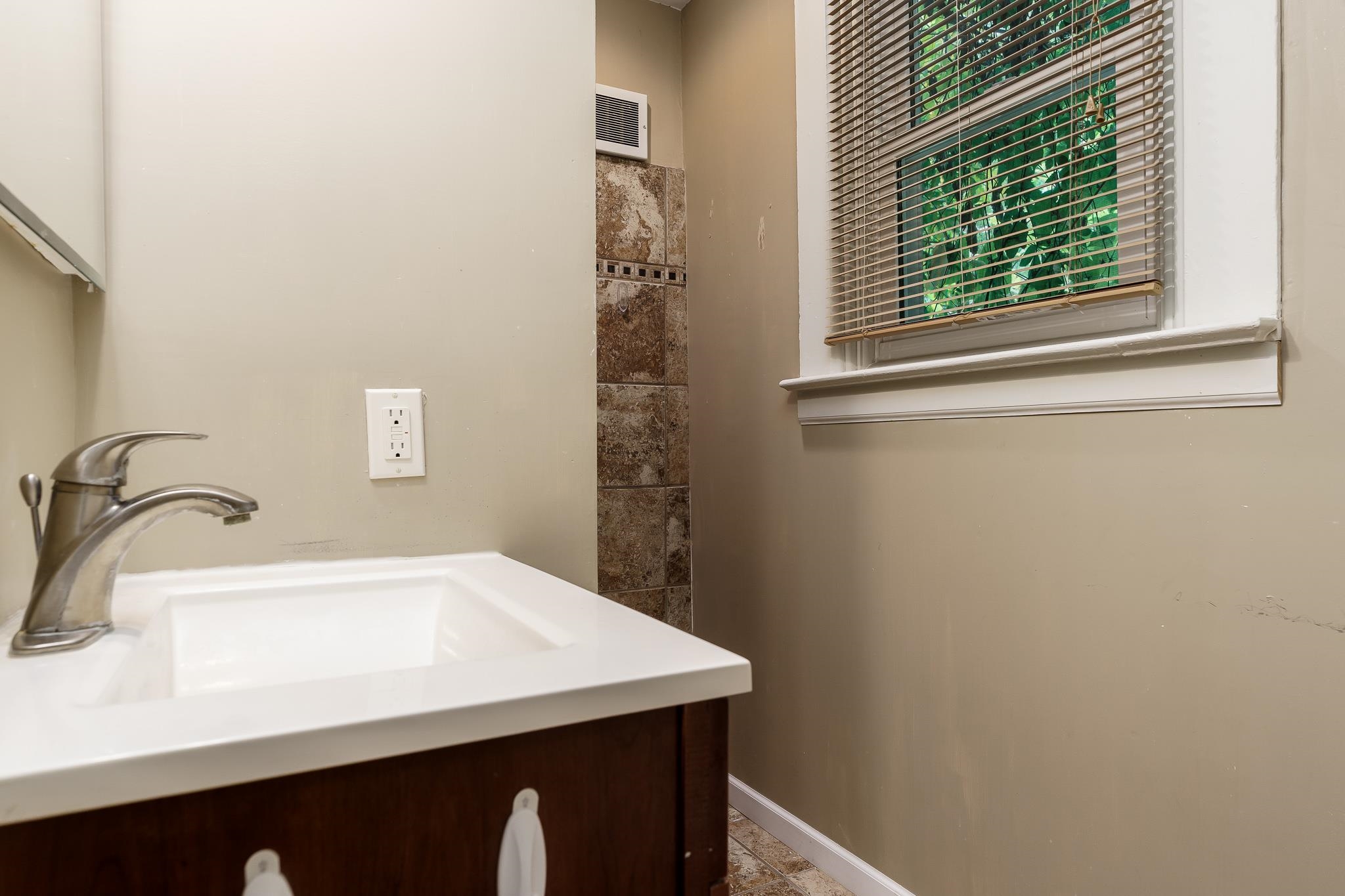 305 West 3rd Street Byron, IL 61010 - Photo 24 of 37 a bathroom with a sink and a mirror