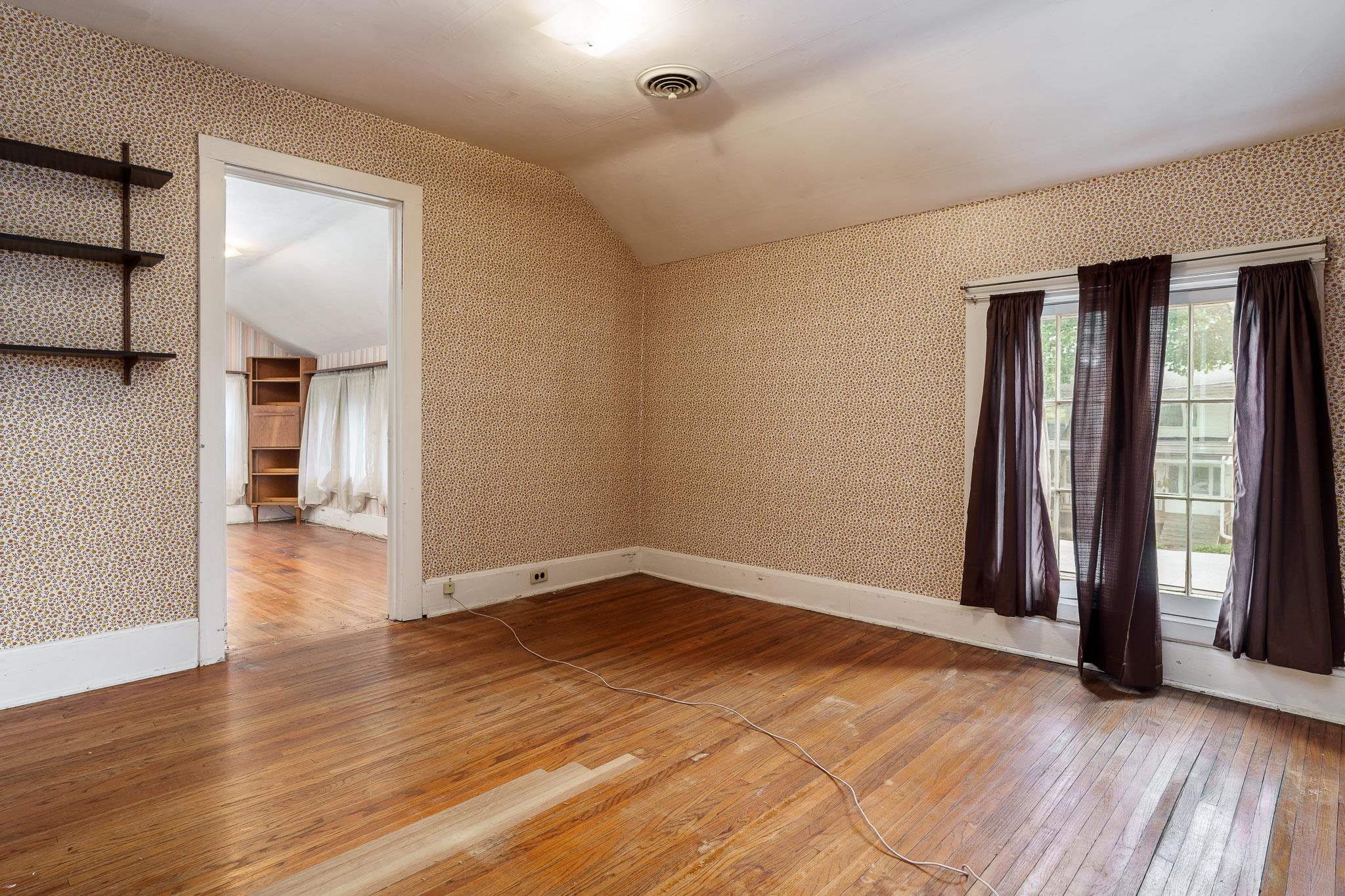 305 West 3rd Street Byron, IL 61010 - Photo 27 of 37 an empty room with wooden floor and a window