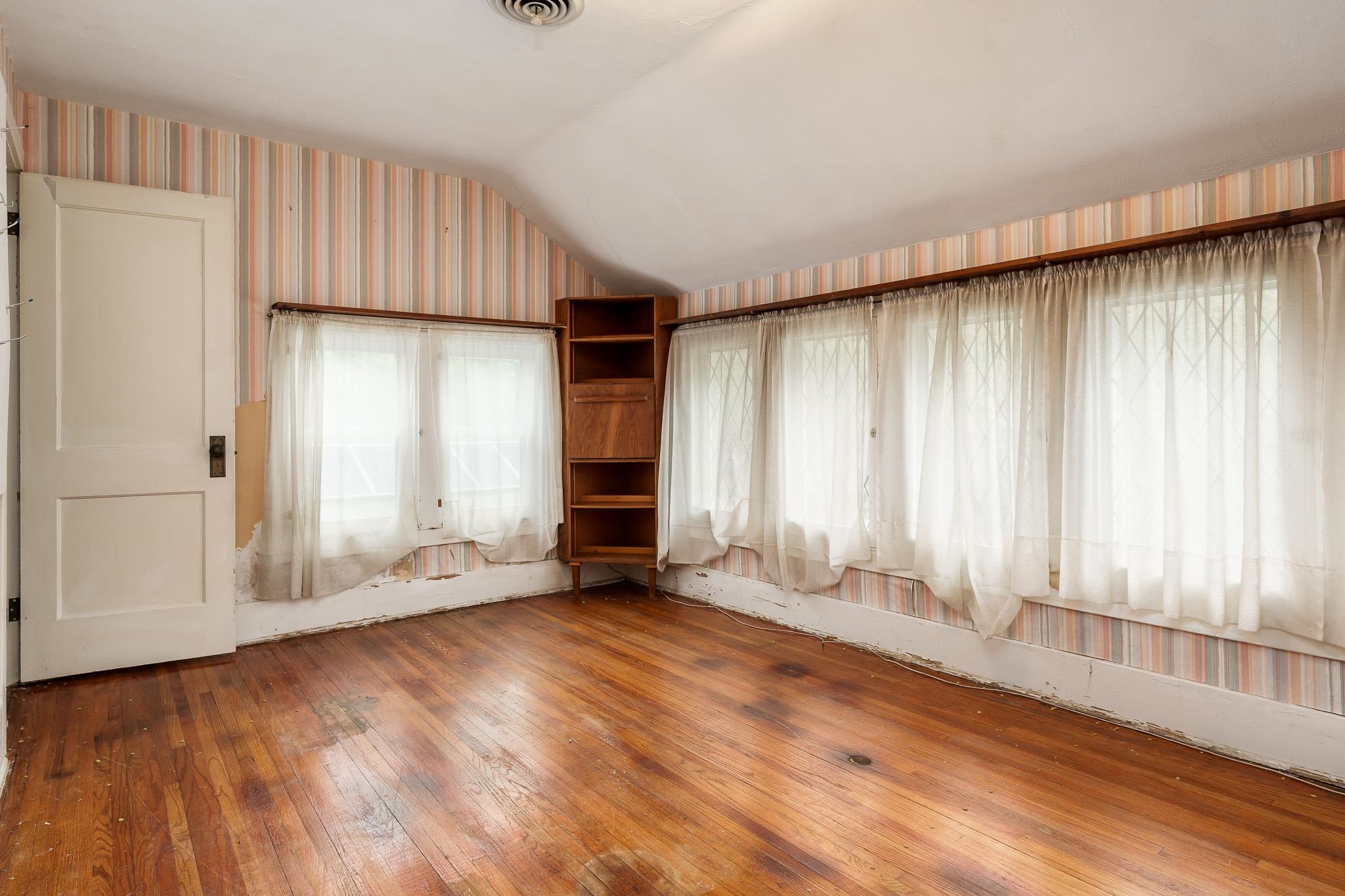305 West 3rd Street Byron, IL 61010 - Photo 29 of 37 an empty room with wooden floor and windows
