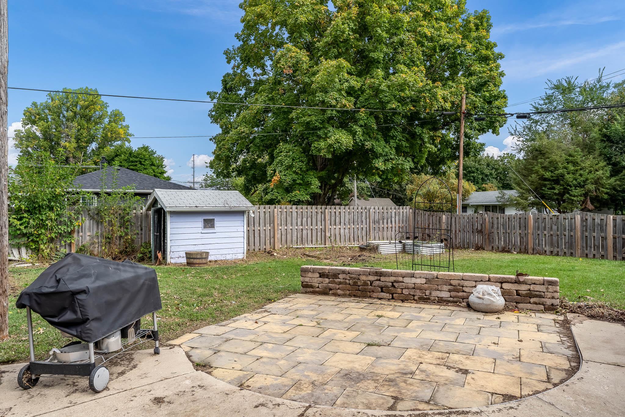 305 West 3rd Street Byron, IL 61010 - Photo 35 of 37 a backyard of a house with barbeque oven
