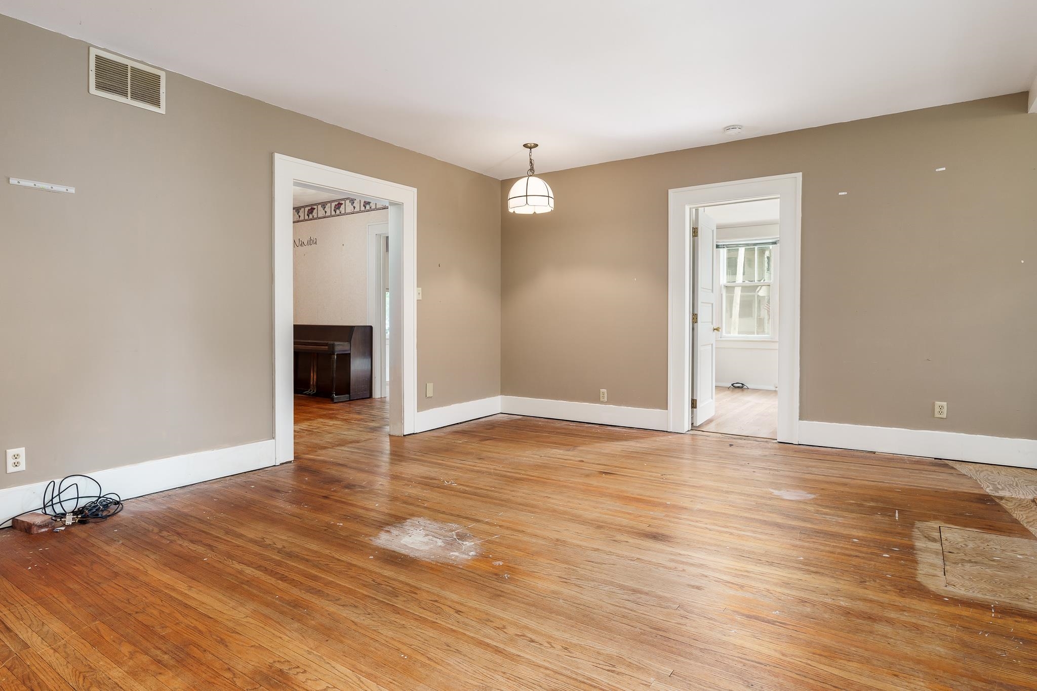 305 West 3rd Street Byron, IL 61010 - Photo 9 of 37 a view of an empty room with wooden floor and a window