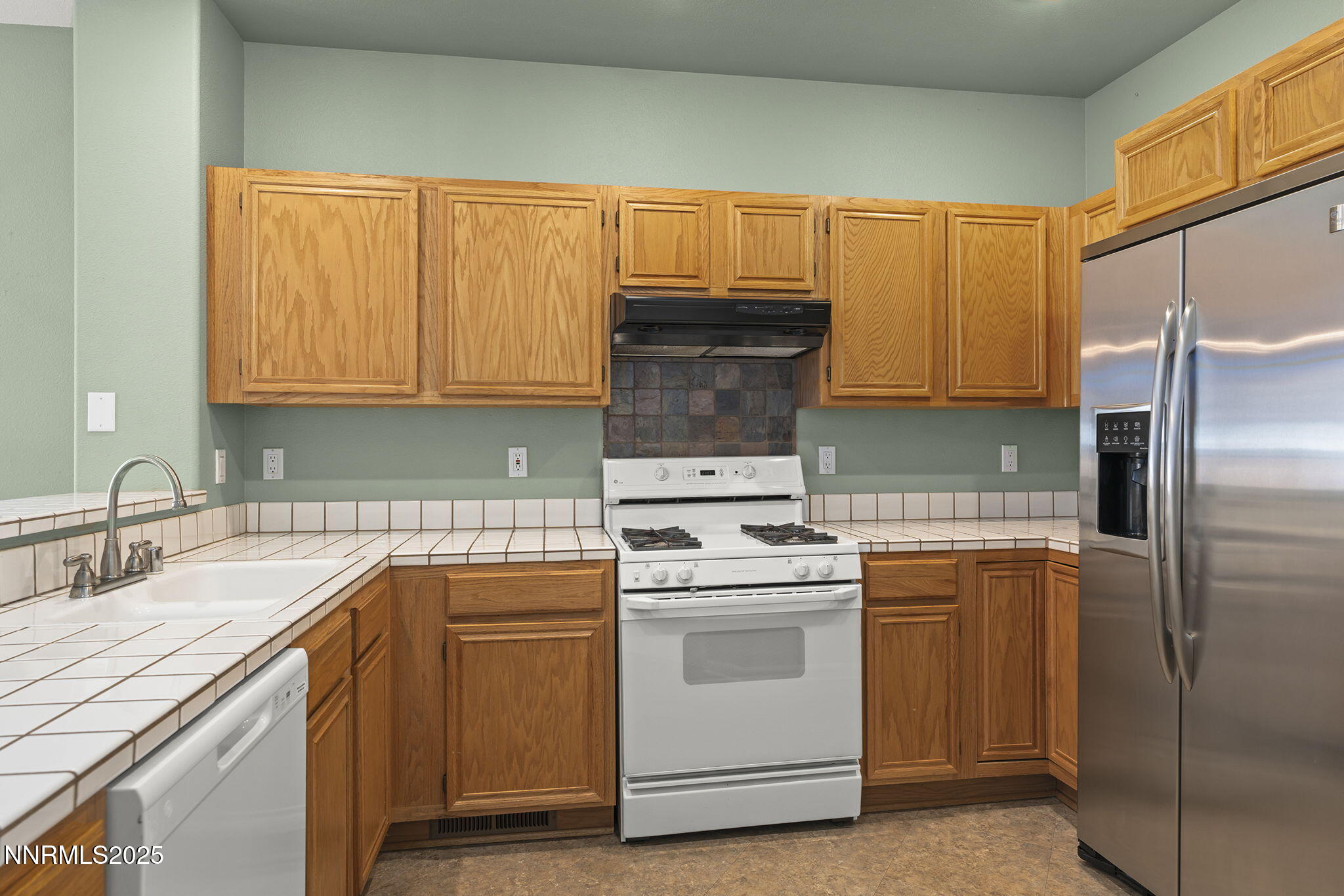 825 Caughlin Crossing, Unit CAUGHLIN RANCH PKWY Reno, NV 89519 - Photo 12 of 35 a kitchen with a sink stove and refrigerator