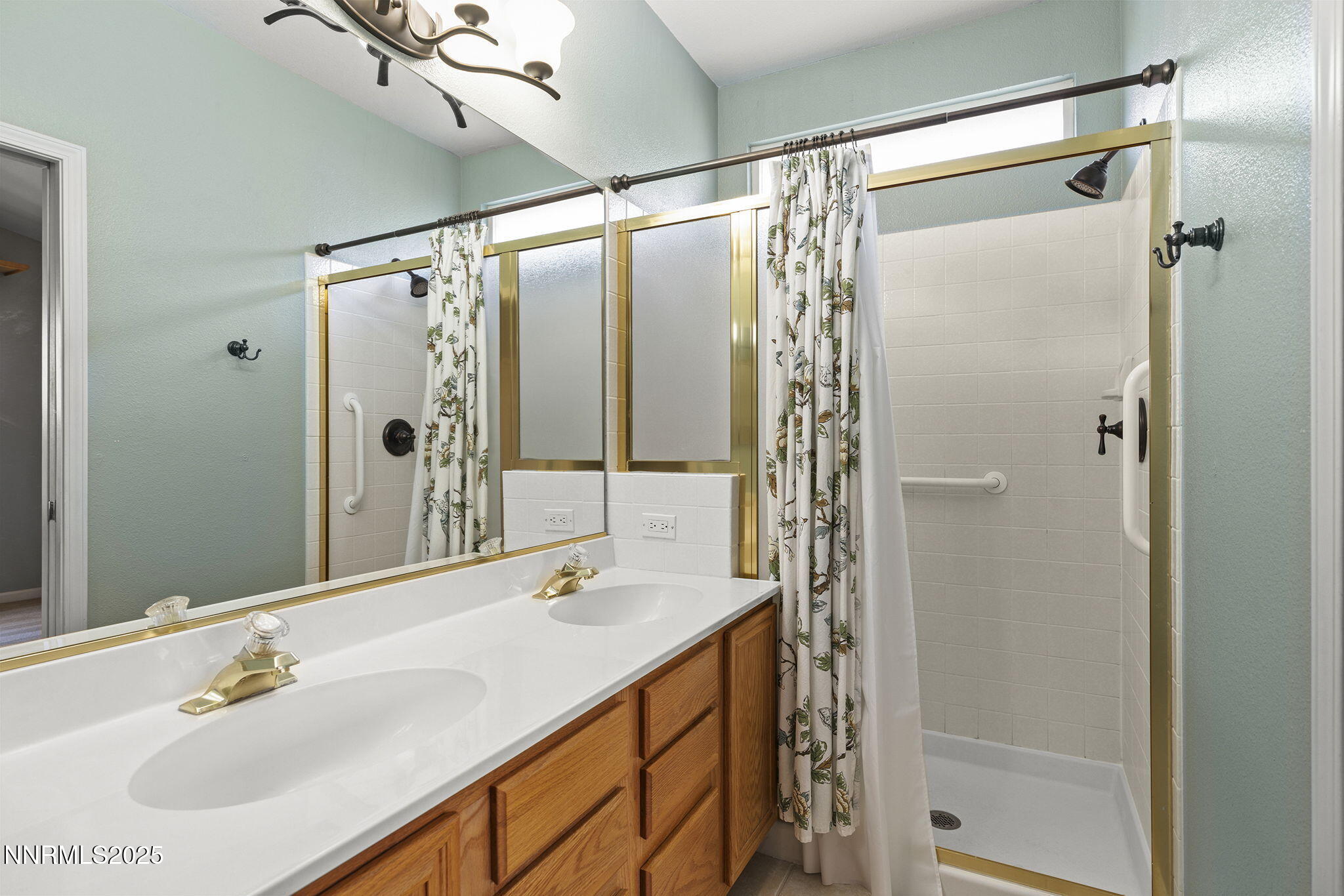825 Caughlin Crossing, Unit CAUGHLIN RANCH PKWY Reno, NV 89519 - Photo 16 of 35 a bathroom with a shower sink and mirror
