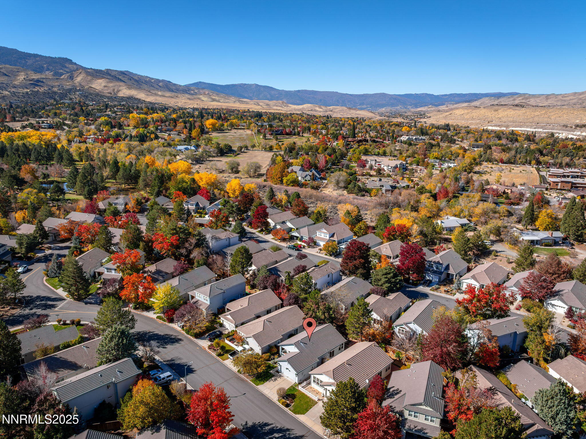 825 Caughlin Crossing, Unit CAUGHLIN RANCH PKWY Reno, NV 89519 - Photo 34 of 35 an aerial view of a city with lots of residential buildings and mountain view in back