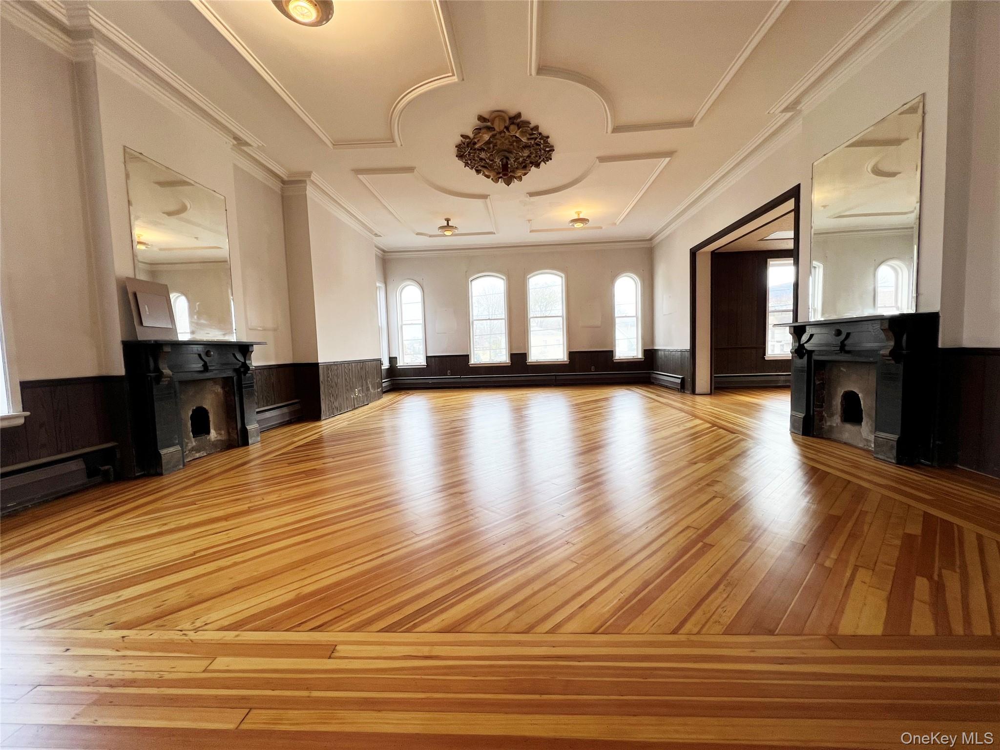 57 East Main Street Beacon, NY 12508 - Photo 4 of 48 a view of a hall with wooden floor and a large window