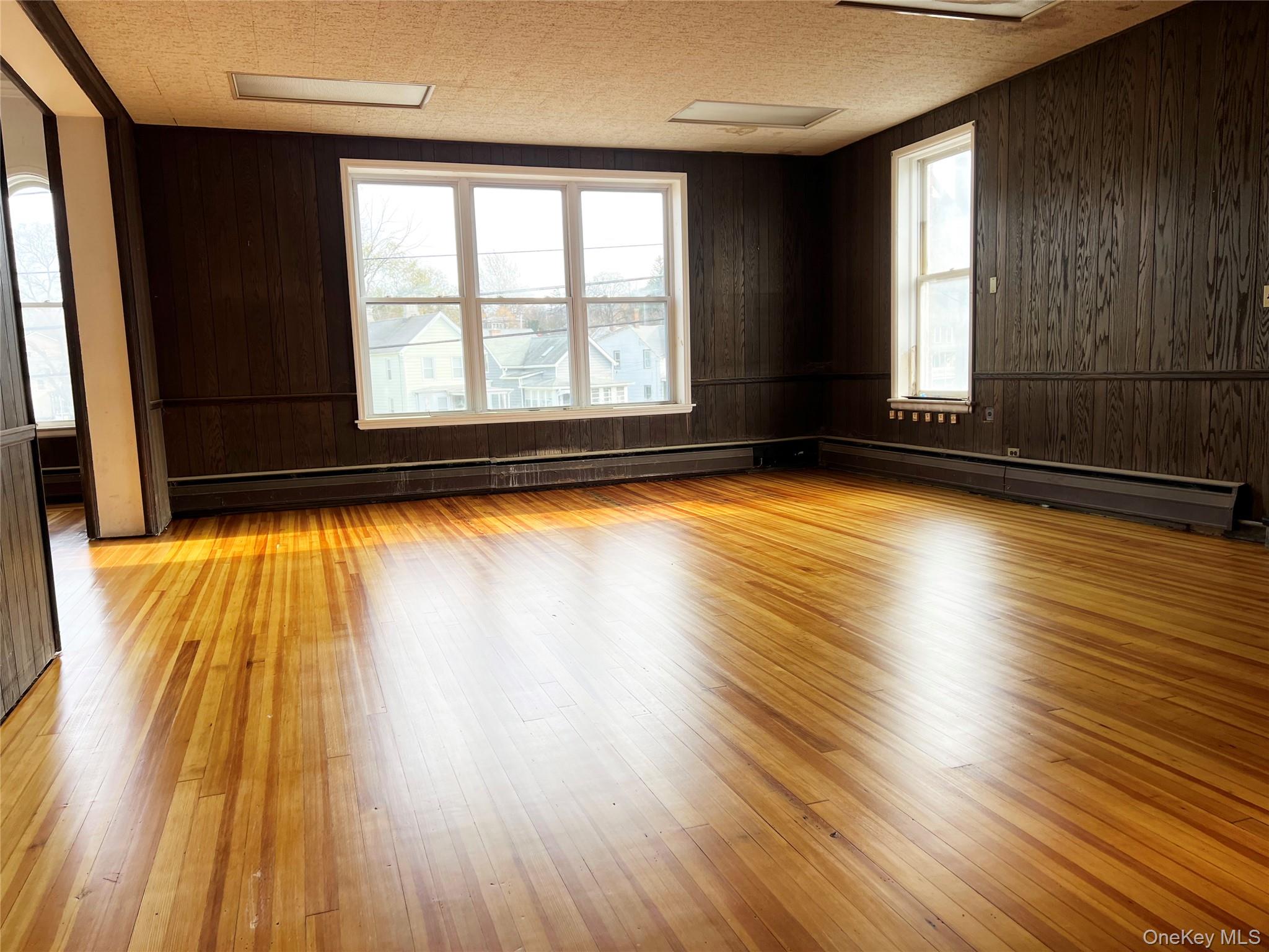 57 East Main Street Beacon, NY 12508 - Photo 8 of 48 an empty room with wooden floor and windows