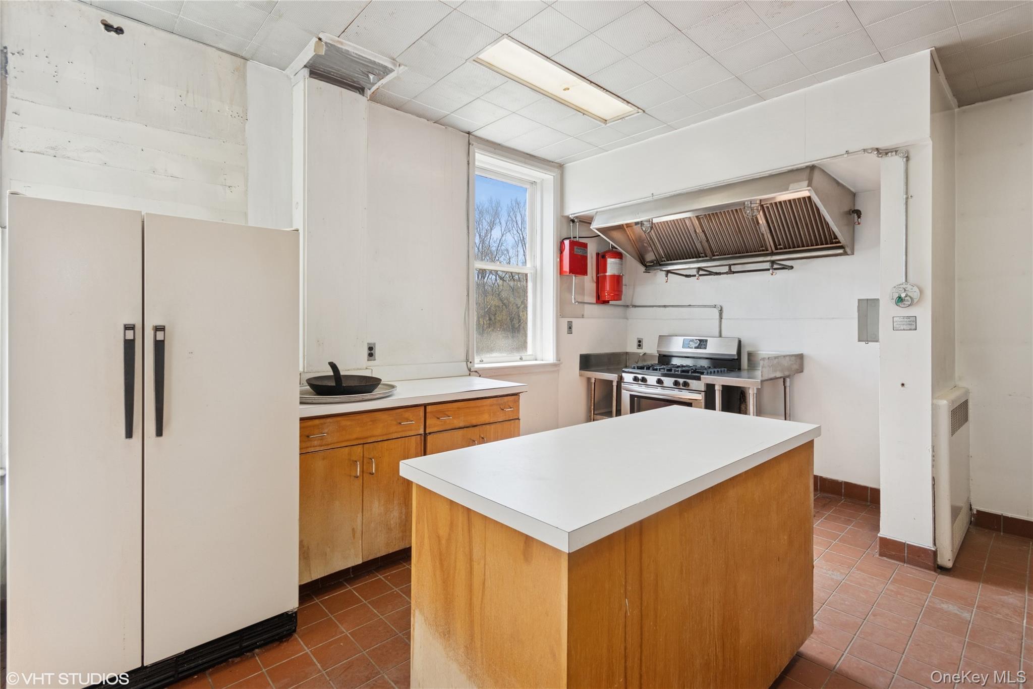 57 East Main Street Beacon, NY 12508 - Photo 9 of 48 a kitchen with stainless steel appliances a stove a refrigerator a sink and a refrigerator