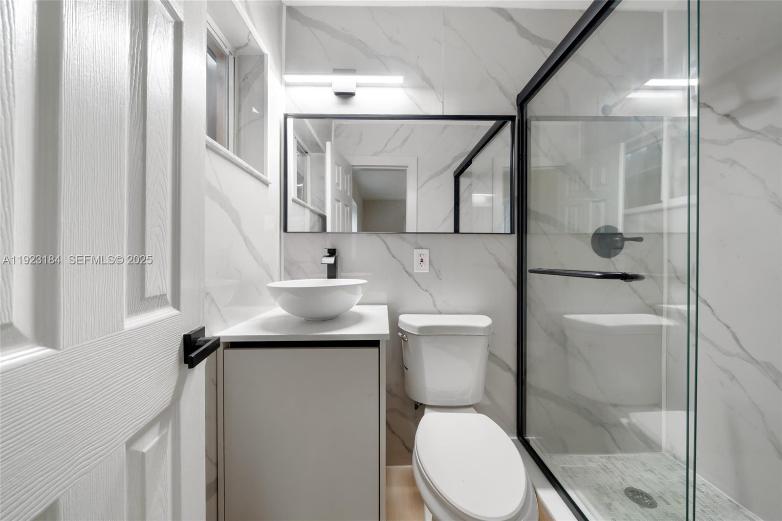 2350 Northwest 56th Street Miami, FL 33142 - Photo 13 of 22 a bathroom with a toilet sink and shower