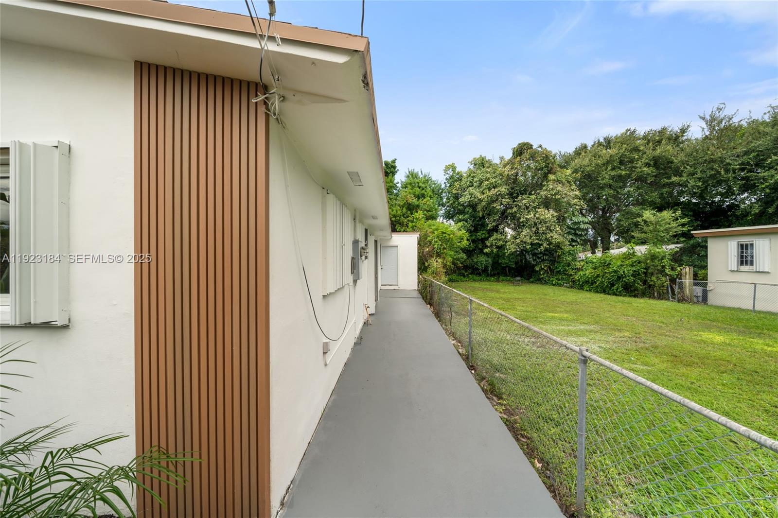 2350 Northwest 56th Street Miami, FL 33142 - Photo 19 of 22 a view of a backyard with pathway