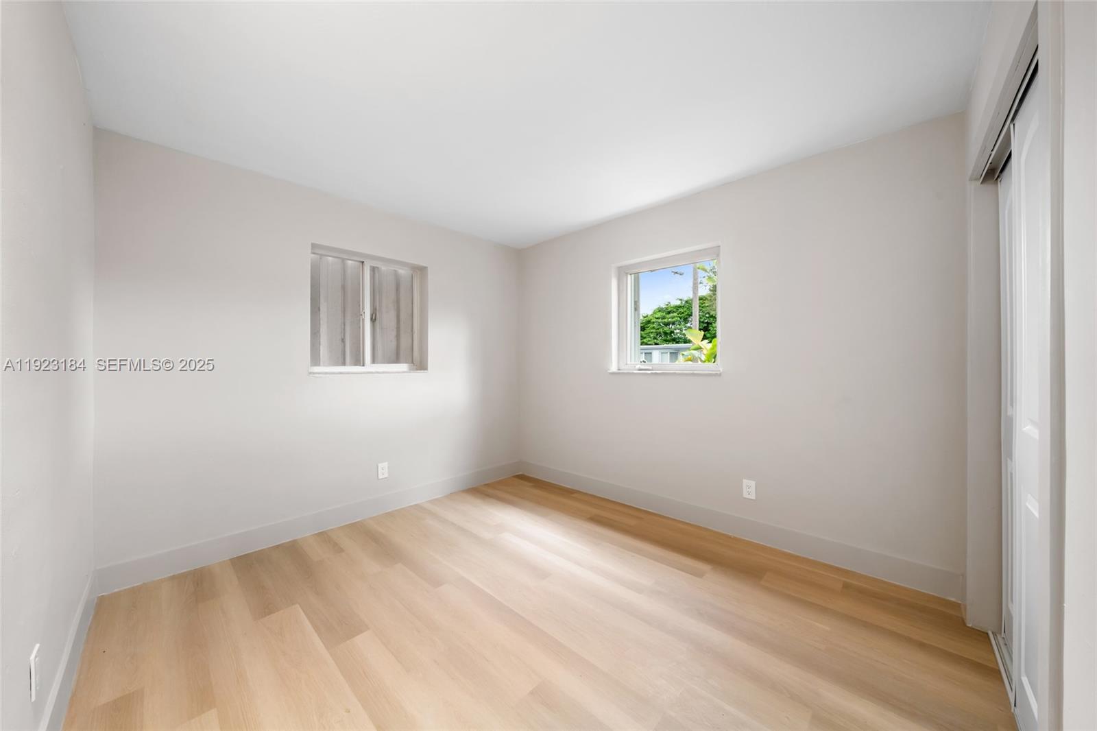 2350 Northwest 56th Street Miami, FL 33142 - Photo 9 of 22 a view of room with window and hardwood floor