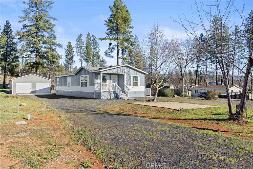 a front view of a house with a yard table and chairs