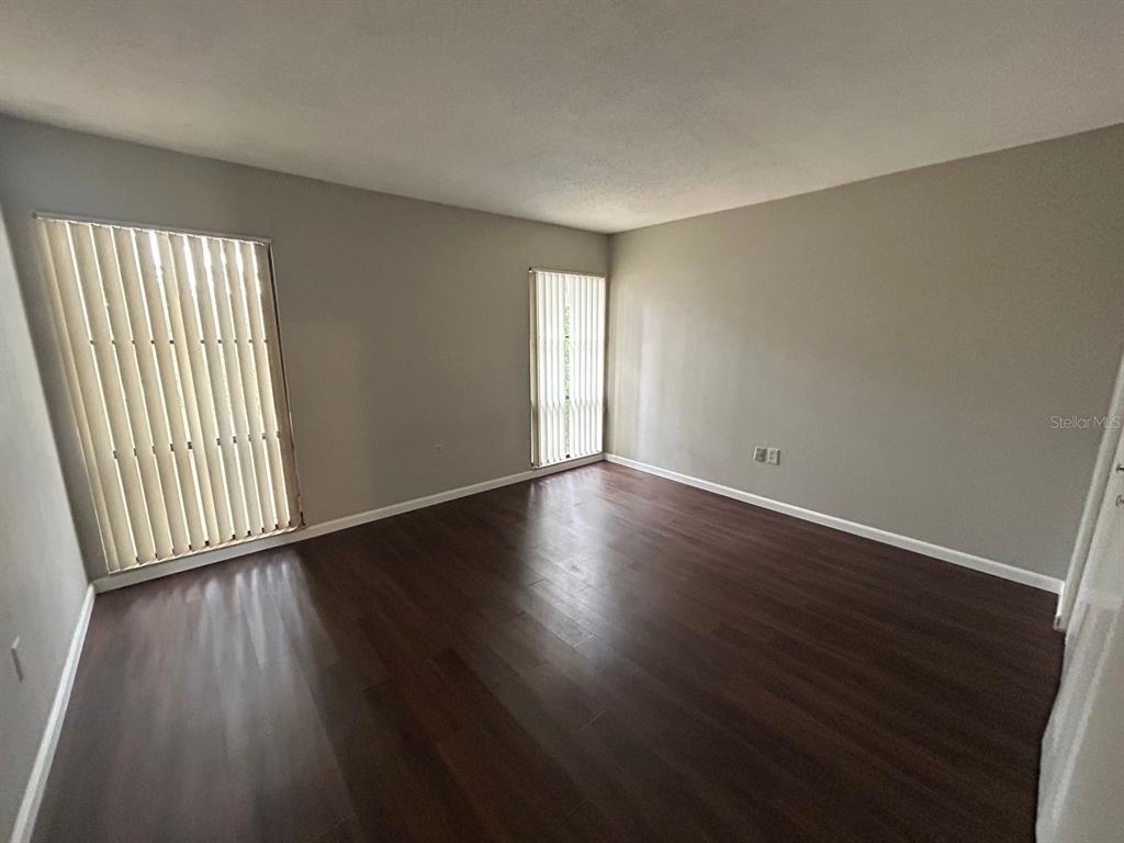 2811 Southwest Archer Road, Unit C18 Gainesville, FL 32608 - Photo 12 of 15 an empty room with wooden floor and windows