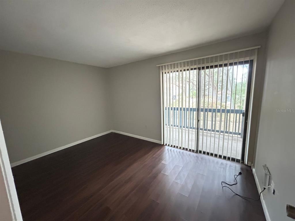 2811 Southwest Archer Road, Unit C18 Gainesville, FL 32608 - Photo 14 of 15 wooden floor in an empty room with a window