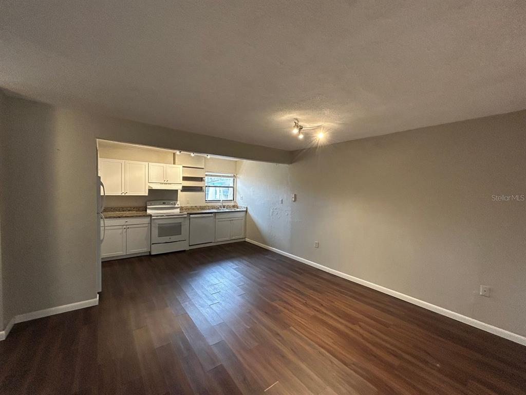 2811 Southwest Archer Road, Unit C18 Gainesville, FL 32608 - Photo 3 of 15 a view of a kitchen with wooden floor and electronic appliances