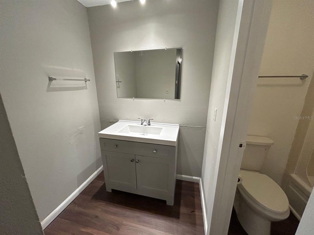 2811 Southwest Archer Road, Unit C18 Gainesville, FL 32608 - Photo 9 of 15 a bathroom with a sink toilet and mirror